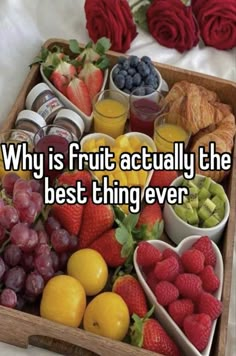 a wooden tray filled with fruits and vegetables