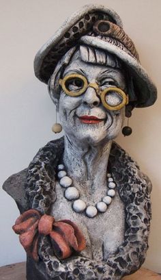 an old woman statue wearing glasses and a hat