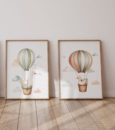 three framed pictures of hot air balloons in the sky, one with a cat on it