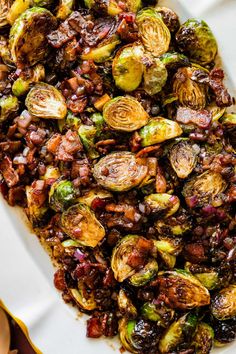 roasted brussel sprouts with bacon on a white platter, ready to be eaten