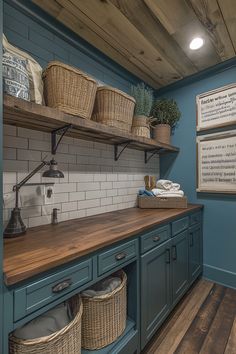 a kitchen with blue cabinets and wooden floors, baskets on the shelves above the sink