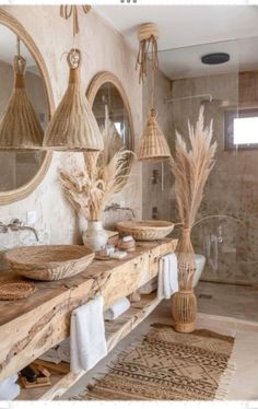 a bathroom with two sinks, mirrors and baskets on the counter top in front of it