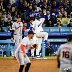 the baseball players are on the field and one is jumping up to catch the ball