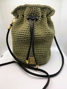 Introducing our handmade crochet bucket bag, thoughtfully crafted for the fashion-forward individual. Made with exceptional attention to detail, this stylish and functional purse is crafted with recycled cotton and polyester blend yarn. The durable shoulder strap ensures comfort and convenience. The green bag has a solid 6 inch round base and the beige bag has a 9 x 41/2 inch oval base, both are 91/2 inches tall and provide spacious interiors with ample room for all your essentials, while the drawstring closure keeps your belongings secure.  Grab your one-of-a-kind accessory today in your choice of natural beige or olive green. To see more unique gift ideas for someone special in your life, please browse our Etsy shop at:  https://lacostaskreations.etsy.com Handmade Bucket Bag Pouch For Travel, Gift Crochet Bucket Bag With Adjustable Strap, Handmade Pouch-shaped Bucket Bag For Travel, Handmade Pouch Bucket Bag For Travel, Travel Crochet Bucket Bag, Crochet Bucket Bag With Adjustable Strap, Daily Use Crochet Bucket Bag, Everyday Crochet Bucket Bag, Crochet Bucket Bag For Everyday Use