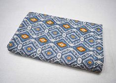 an orange and blue pattern is on top of a white surface with a zippered pouch