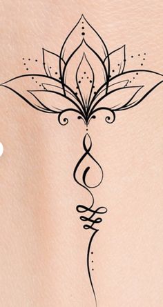 a woman's back with a tattoo design on it