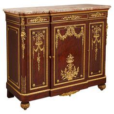 an ornately decorated cabinet with marble top