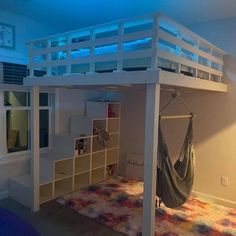 a loft bed with a hammock hanging from the top