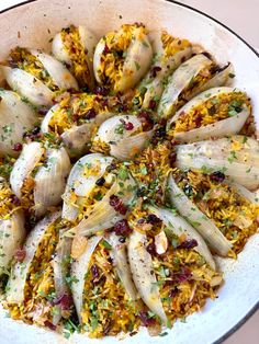 a white bowl filled with chicken and rice covered in seasoning sprinkles