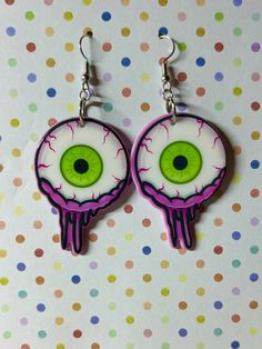 Hey Spooky Babes! Here are some spooky sweet Eyeball drop earrings! They are on nickel free fish hook ear wires  Approximately 2.75 inches long and 1 inch wide, with a double sided charm.  Have gauges?? I can put most designs on a hoop to go through your tunnels! I can also put most designs on studs, clip-ons etc, just message me and I'll be happy to help!! Orders of $30 or more will receive Free Standard Shipping, upgraded shipping can be purchased on request. Buy 2 or more items to get  a Free surprise gift!!  The more items you buy, The more  free surprises you'll receive! Free enamel pins, horror magnets, stickers, earrings, keyrings and more! Follow me on Instagram for shop updates and more! And please, if you love your purchase, tag me in your stories! Thank you! @JPgingerCrafts Retu Horror Earrings, Eyeball Earrings, Valentines Day Earrings, Spooky Earrings, Earrings Goth, Earrings Punk, Goth Earrings, Punk Earrings, Earrings Halloween