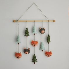 a wall hanging with bear and pine trees on it's sides, made out of wood