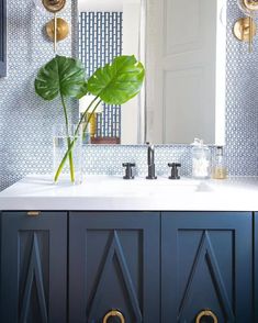 a bathroom sink with a large green plant in it