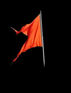 an orange flag is flying in the dark