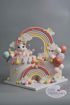 a cake that is shaped like a castle with a rainbow and stars on the top