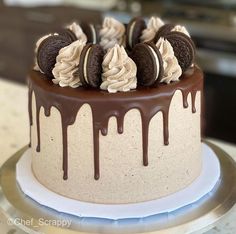 a chocolate cake with oreo cookies and cream on top