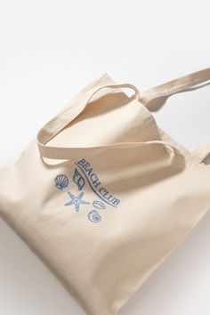 a tote bag with the words briccup on it and some seashells