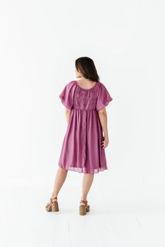 Features Round neckline Short puff sleeve with elastic cuff Elastic waist Smocked back Fully lined Pockets Deep orchid color with shimmer overlay Dress & Lining: 100% Polyester Size + Fit XS 00-2, Small 2-6, Medium 8-10, Large 12-14, X-Large 14-16, 2X 20-22, 3X 24-26, 4X 28-30 Kristin is 5'4", a size 1 and is wearing a Small Jaycie is 5'6", a size 18 and is wearing a 2X Runs true to size. Bust Measurements taken while laying flat and then doubled. They do no account for stretch. Click here for s Curvy Swim, Dress Lining, Orchid Color, Christmas In July Sale, Shimmer Dress, Short Puff Sleeve, Overlay Dress, Curvy Dress, Resort Collection