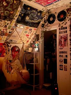 a room with various items hanging from the ceiling and pictures on the wall above it