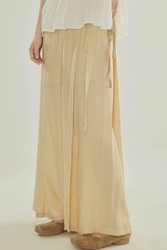 Inspired by Song Ku 宋裤 (Song Dynasty trousers), these wide legged pants are perfect for daily wear. Made of light and breezy fabric, these pants are lined within to ensure no flashes. Features the traditional waist tie but paired with a modern zipper closure. Triangular side pleats, creating the iconic flared shape. Wear as-is or under skirts! These fun pants can easily be styled with modern and traditional pieces. This item has a 7 day construction period. Materials: 82.6% viscose, 17.4% nylon Beige Wide Leg Full Length Pants For Spring, Relaxed Fit Wide Leg Maxi Skirt For Daywear, Solid Wide Leg Pants For Daywear, Beige Wide Leg Harem Pants For Spring, Beige Elastic Waistband Wide-leg Harem Pants, Beige Wide-leg Harem Pants With Elastic Waistband, Beige Wide Leg Pants For Spring Daywear, Elastic Waistband Wide Leg Pants For Daywear, Spring Daywear Wide Leg Harem Pants