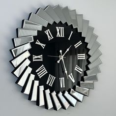 a clock that has roman numerals on the front and sides of it's face