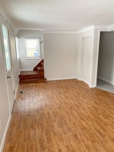 an empty room with hard wood flooring and white paint on the walls is shown