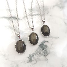 Beautiful Golden Sheen Obsidian Pendants on your choice of Chain or Waxed Cotton Cord, with a specially chosen Gemstone Tumble stone in a Gift Pouch. Obsidian is a Protective Gemstone which can be good for Calming emotions too. The Stainless Steel chain is hypoallergenic. The Silver is 925 Sterling Silver. The Dark Chain is nickel & lead free. The Cords are Waxed Cotton. You should always seek medical advice from your GP or Healthcare Professional if you are unwell. Crystals should never be used Silver Obsidian Jewelry For Healing, Obsidian Natural Stones Necklace For Gift, Gift Obsidian Necklaces With Natural Stones, Gift Obsidian Necklace With Natural Stones, Silver Obsidian Gemstone Necklace, Silver Obsidian Necklaces, Silver Obsidian Necklace With Natural Stones, Obsidian Gemstone Necklace For Gift, Golden Sheen Obsidian