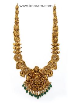 22 Karat Gold "Lakshmi - Peacock" Long Necklace with Beads & Pearls (Temple Jewellery)  Enhance Your Beauty with 22 Karat Gold "Lakshmi - Peacock" Long Necklace  This exquisite piece of temple jewelry is a symbol of elegance and tradition. Made in India by skilled artisans, this 22 Karat gold necklace is a timeless treasure that will add a touch of sophistication to any outfit. The intricate design featuring Lakshmi and peacock motifs, along with beads and pearls, exudes luxury and grace. The ne Long Temple Jewellery, Long Temple Jewellery Necklace, Long Chains Indian Gold Traditional, Gold Long Necklace With Grams, Lakshmi Necklace Gold, Gold Temple Jewellery Necklace Set, Gold Long Chains Indian Jewellery, Long Gold Chain Designs For Women, Long Necklace Gold Indian Bridal