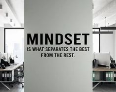 an office wall with the words mindset is what separates the best from the rest