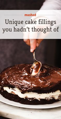 a person is spooning chocolate cake fillings into the frosting on a white plate