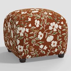 an orange and white ottoman with flowers on it