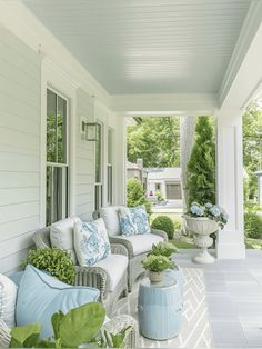 the porch is decorated with blue and white furniture