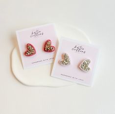 "Welcome to KatieCollinsXO. How fun are these large stud earrings that will get you in the spirit for Valentine's Day?! Including are either pale pink silver stud earrings or red and gold stud earrings. Both are made from polymer clay and crushed glass stones, sealed with UV resin for added shine. Truly one-of-a-kind, all of my earrings are lovingly handmade by me with extremely lightweight polymer clay, and come with stainless steel backs. I also make them super affordable so that you can gift them to all of your girlfriends this Galentine's Day! I also offer FREE shipping on all orders over $35 as well as two FREE gifts with purchase. DETAILS - Gold or silver crushed glass stone detail. - Handmade from polymer clay. - Stainless steel backs. - FREE shipping on orders over $35. - Ships in Polymer Clay Heart Earrings As Valentine's Day Gift, Valentine's Day Gift Polymer Clay Heart Earrings, Heart Shaped Polymer Clay Earrings, Fun Heart-shaped Earrings For Valentine's Day, Valentine's Day Heart-shaped Polymer Clay Earrings, Large Stud Earrings, Heart Studs, Heart Earrings Studs, Red And Gold