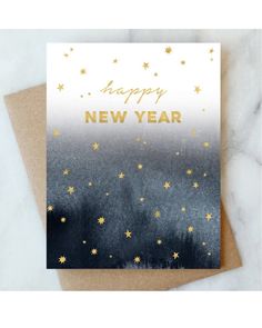 a happy new year card with gold foil stars on it and the words, happy new year