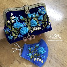 a blue purse with flowers painted on it