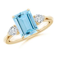 an aqua blue topazte and diamond ring with three diamonds on the shoulders, set in yellow gold