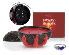 the dragon's claw candle is next to a ring and box with its cover open