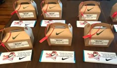 several boxes with ribbons tied around them on a table