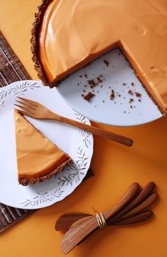 there is a piece of pie on the plate and two forks in front of it