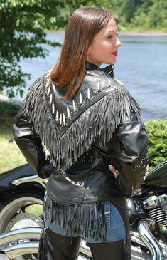 Genuine bone filled western motorcycle jacket for women. This fringe leather jacket is exclusively offered by Jamin Leather® and is made of top grain, premium buffalo leather. This black leather jacket for women features double layer fringe, 2" bone beading on front and back, mini studding along western scallop trim, zip out lining for cool weather riding, long front zipper, wind flap zipper cover, mandarin collar with snap flap, zippered front pocket to keep your stuff in, zip cuffs to keep the Motorcycle Jacket Women, Fringe Leather Jacket, Leather Travel Bag, Leather Skin, Leather Hats, Leather Shirt, Bone Beads, Buffalo Leather, Leather Collar