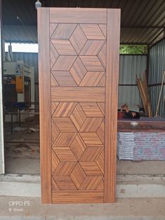 a large wooden door sitting in the middle of a room next to a pile of bricks