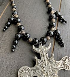 This beautiful, one-of-a-kind pewter ornate cross necklace will inspire all your moonlit nights. Handmade with black agate and glass beads. Measures 18 inches long and has a 2 inch extender chain. product details silver tone metals; Cross is soft pewter. 18 inches long with 2 inch extender black agate and glass beads VISIT MY SHOPS HERE * http://www.etsy.com/shop/HappyCatHouse * http://www.Etsy.com/shop/AnEnchantingCreature CONNECT * http://www.facebook.com/EnchantingCreature * https://www.insta Gothic Ankh Necklace In Metal, Gothic Ankh Metal Necklace, Gothic Black Crucifix Cross Necklace, Gothic Cross Necklace For Festivals, Gothic Metal Jewelry With Black Beads, Gothic Nickel-free Cross Jewelry, Gothic Beaded Cross Jewelry, Gothic Black Beaded Metal Jewelry, Gothic Silver Jewelry With Black Beads