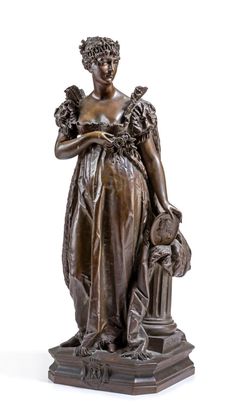 a bronze statue of a woman holding flowers