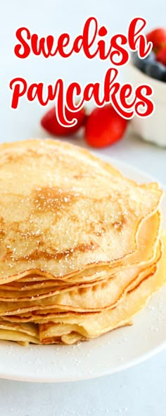 pancakes on a plate with strawberries in the background and text overlay that reads, swedish pancakes