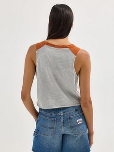 Discover your new go-to for every game in the Women’s Wrangler® Collegiate Vintage Muscle Tee. This vintage-inspired sleeveless muscle tank delivers the school spirit you want, with a distressed print of your team's logo, name, and founding date across the front. It’s crafted from a comfortable cotton blend, complete with a raw edge hem, a cropped length, and your team’s color at the shoulders. This graphic tank will quickly become your go-to for game day. Casual Cotton Racerback Tank Top, Casual Sleeveless Tank Top For College, Cotton Tank Top For College In Summer, Casual Summer Tank Top For College, Sleeveless Tops For College Summer, Sleeveless Summer Tops For College, Sporty Tank Top For College In Summer, Sporty Summer Tank Top For College, Cotton Racerback Muscle Tee For Summer