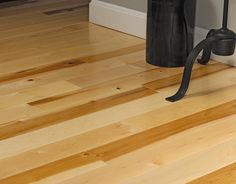 a wooden floor with a black handle on it