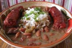 a bowl filled with beans, rice and sausage