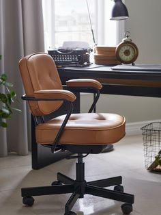 an office chair sitting in front of a desk with a clock on the wall behind it