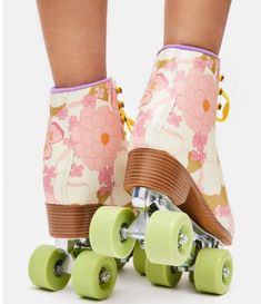 a close up of a person's feet on a skateboard with green wheels