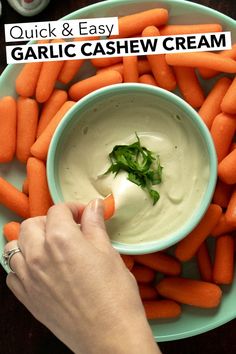 a person dipping sauce into a bowl of carrots with the words quick and easy garlic cashew cream