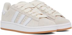 Low-top suede and buffed leather sneakers in off-white. · Lace-up closure · Logo embossed at padded tongue and heel tab · Padded collar · Text embossed at outer side · Perforated detailing and signature serrated stripes at sides · Terrycloth lining · Treaded rubber sole Supplier color: Wonder white/Ftwr white/Gum Cream Suede Sneakers For Streetwear, White Suede Adidas Logo Sneakers, Adidas Cream Leather Sneakers, Cream Leather Adidas Sneakers, Sporty Cream Leather Skate Shoes, White Adidas Suede Skate Shoes, White Suede Skate Shoes With Laces, White Suede Adidas Skate Shoes, Cream Leather Lace-up Skate Shoes